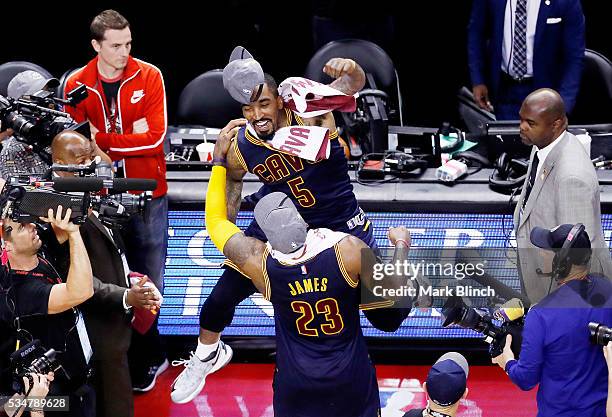 LeBron James and J.R. Smith of the Cleveland Cavaliers celebrate their 113 to 87 win over the Toronto Raptors in game six of the Eastern Conference...