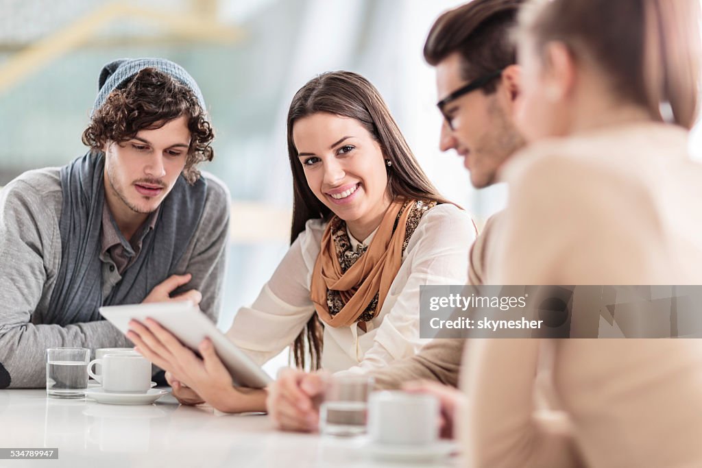 Young people using digital tablet.