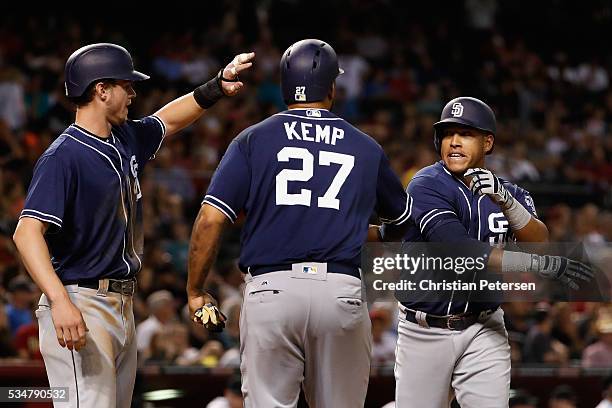 Yangervis Solarte of the San Diego Padres high-fives Wil Myers and Matt Kemp after Solarte hit a three-run home run against the Arizona Diamondbacks...