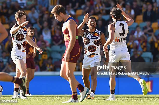 Cyril Rioli of the Hawks celebrates kicking a goal with team mates during the round 10 AFL match between the Brisbane Lions and the Hawthorn Hawks at...