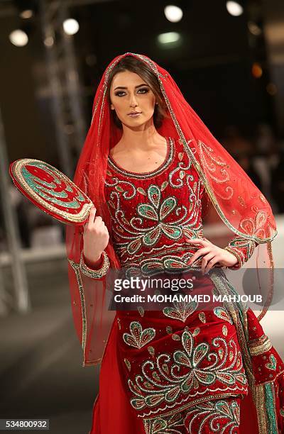 Model displays a creation by Omani designer Anisa al-Zadjali during the launch of the 4th edition of the Ladies a La Mode fashion show, on May 27 in...