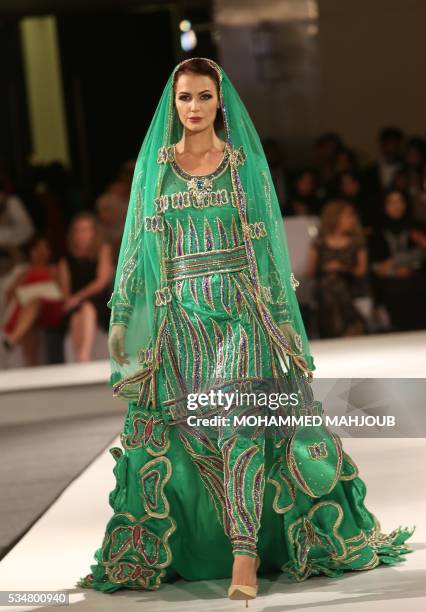 Model displays a creation by Omani designer Anisa al-Zadjali during the launch of the 4th edition of the Ladies a La Mode fashion show, on May 27 in...