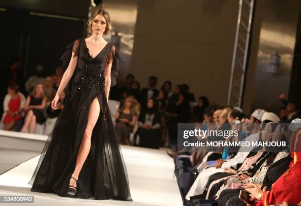 Model displays a creation by Lebanese designer Abed Mahfouz during the launch of the 4th edition of the Ladies a La Mode fashion show, on May 27 in...