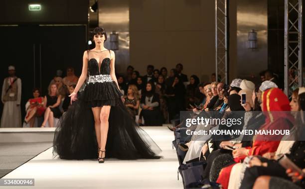 Model displays a creation by Lebanese designer Abed Mahfouz during the launch of the 4th edition of the Ladies a La Mode fashion show, on May 27 in...