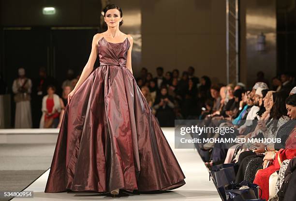 Model displays a creation by Lebanese designer Abed Mahfouz during the launch of the 4th edition of the Ladies a La Mode fashion show, on May 27 in...