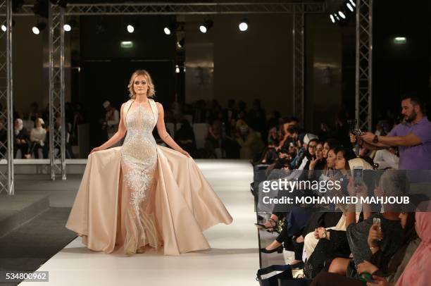 Model displays a creation by Lebanese designer Antoine Salameh during the launch of the 4th edition of the Ladies a La Mode fashion show, on May 27...