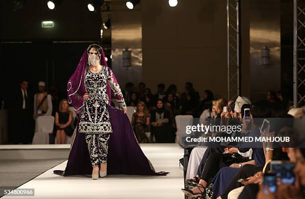 Model displays a creation by Omani designer Anisa al-Zadjali during the launch of the 4th edition of the Ladies a La Mode fashion show, on May 27 in...