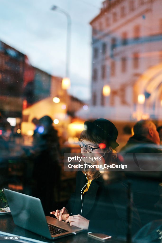 Woman in Cafe with Free WiFi