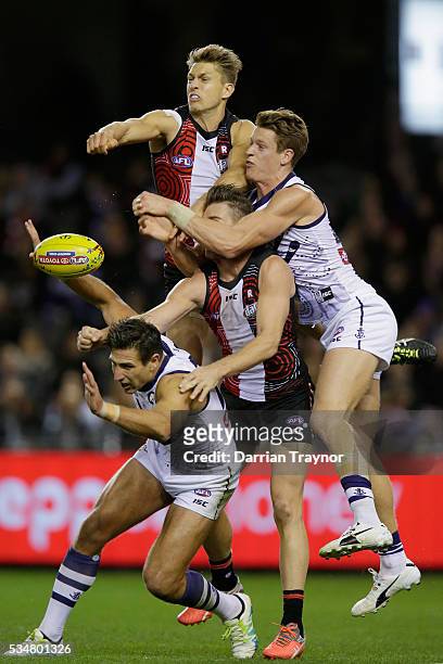Sean Dempster of the Saints spoils the ball over team mate Sam Fisher and Matthew Pavlich of the Dockers during the round 10 AFL match between the St...