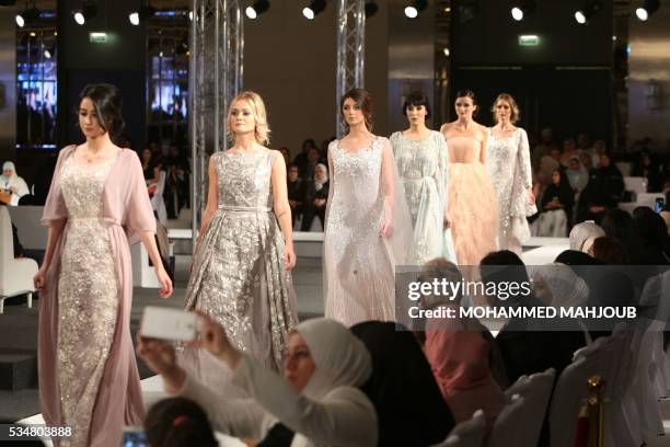 Models display creations by Omani designer Buthaina al-Zadjali during the launch of the 4th edition of the Ladies a La Mode fashion show, on May 27...