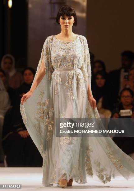 Model displays a creation by Omani designer Buthaina al-Zadjali during the launch of the 4th edition of the Ladies a La Mode fashion show, on May 27...