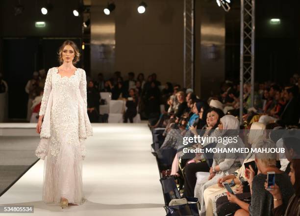 Model displays a creation by Omani designer Buthaina al-Zadjali during the launch of the 4th edition of the Ladies a La Mode fashion show, on May 27...