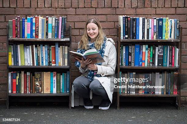 Jana Fachmann reads a book at Hay Cinema Bookshop during the 2016 Hay Festival on May 26, 2016 in Hay-on-Wye, Wales. The Hay Festival is an annual...