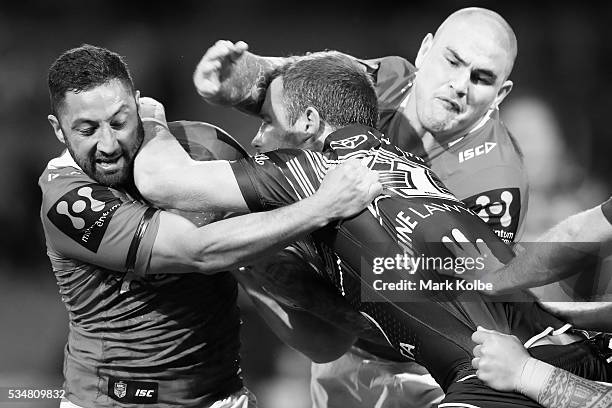 Gavin Cooper of the Cowboys is tackled by Benji Marshall and Russell Packer of the Dragons during the round 12 NRL match between the St George...