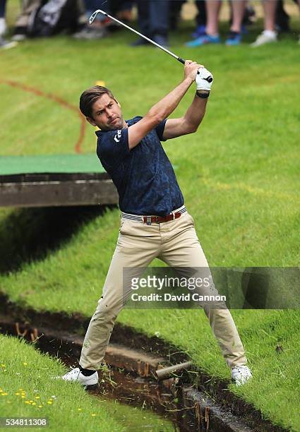 Robert Rock of England hits his 2nd shot on the 7th hole during day three of the BMW PGA Championship at Wentworth on May 28, 2016 in Virginia Water,...