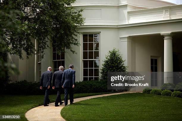 President George W. Bush walks outside the White House in Washington, DC with Homeland Security Security Michael Chertoff and Commerce Secretary...