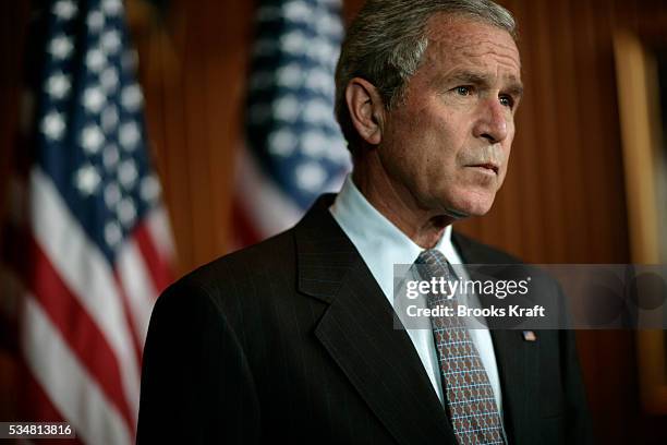 President George W Bush speaks to reporter following his visit to the Walter Reed Army Medical Center in Washington, DC. Bush refused to rule out an...