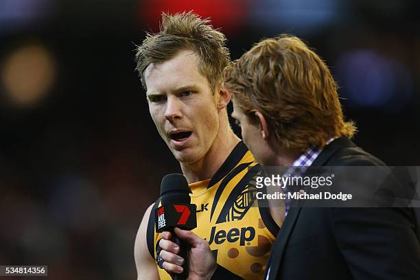 Jack Riewoldt of the Tigers speaks to Cameron Ling of Channel Seven at half time during the round 10 AFL match between the Essendon Bombers and the...