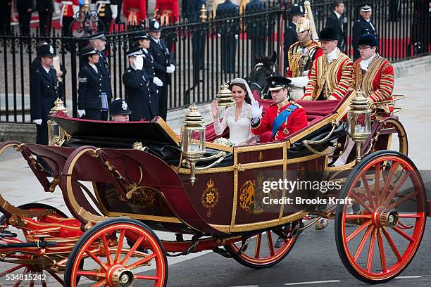 Britain's Prince William and his wife Catherine, Duchess of Cambridge, leave after their wedding in Westminster Abbey in the 1902 State Landau along...