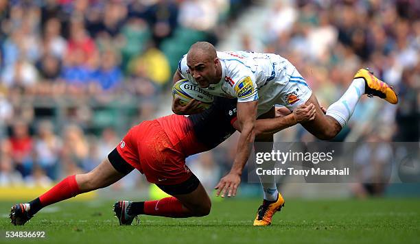 Olly Woodburn of Exeter Chiefs is tackled by Alex Goode of Saracens during the Aviva Premiership final match between Saracens and Exeter Chiefs at...