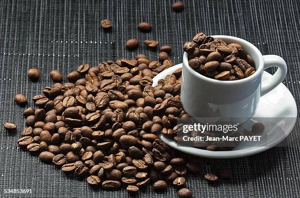 coffee cup filled with coffee beans - jean marc payet photos et images de collection