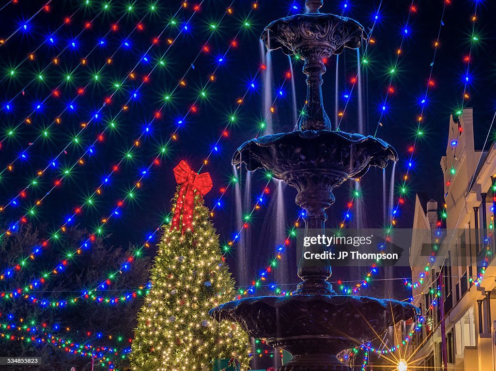 Fountain at night with holiday lights