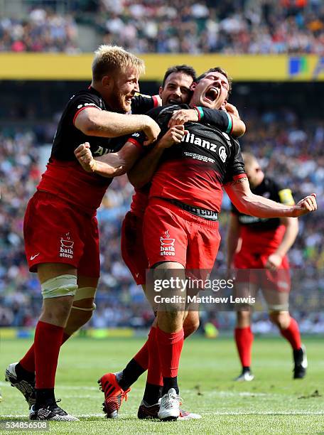 Alex Goode of Saracens celebrates scoring his team's third try with his team mates during the Aviva Premiership final match between Saracens and...