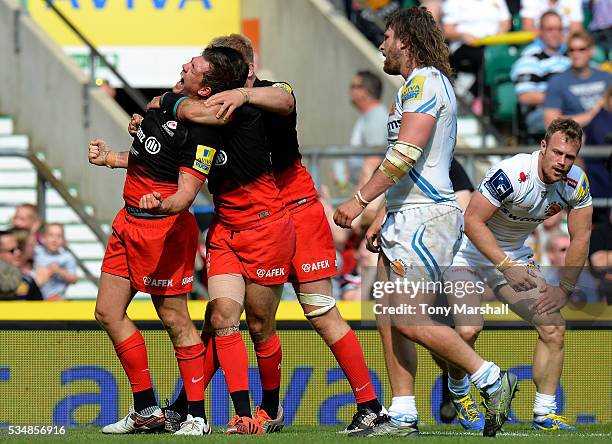 Alex Goode of Saracens celebrates scoring his team's third try with his team mates during the Aviva Premiership final match between Saracens and...