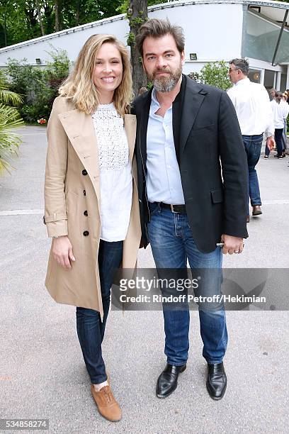 Actors Clovis Cornillac and his wife Lilou Fogli attend Day Seven of the 2016 French Tennis Open at Roland Garros on May 28, 2016 in Paris, France.