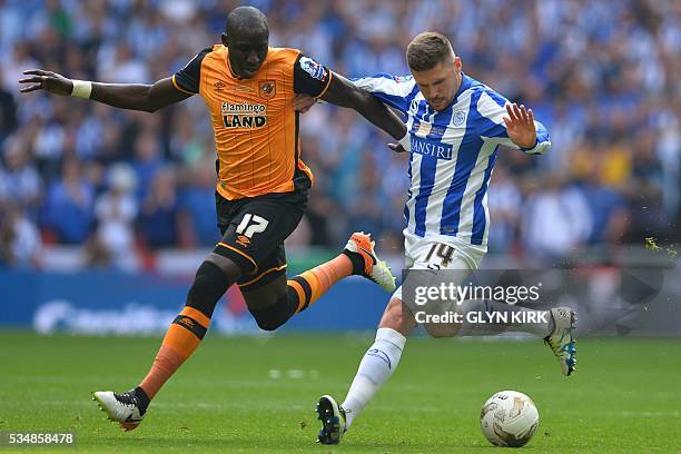 Hull City's French-born Senegalese midfielder Mohamed Diame vies with Sheffield Wednesday's English striker Gary Hooper during the English...