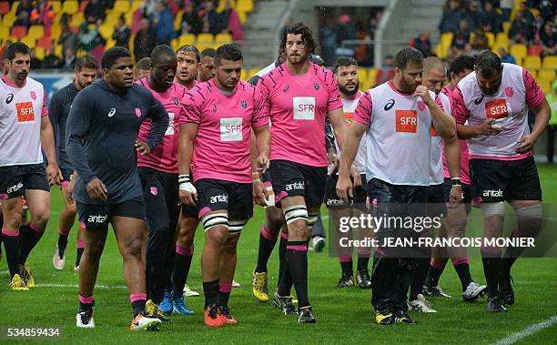 Stade Français' players leave the pitch after warming up prior to the French Top 14 rugby union match between Agen and Stade Français, on May 28,...