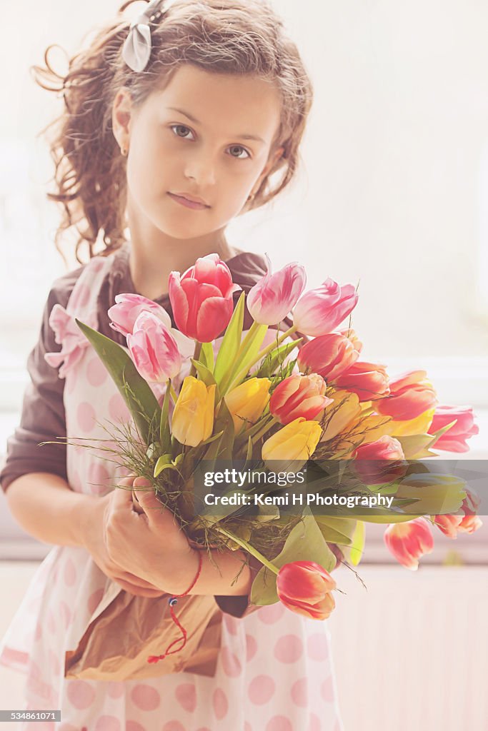 Beautiful brunette girl with tulip flowers