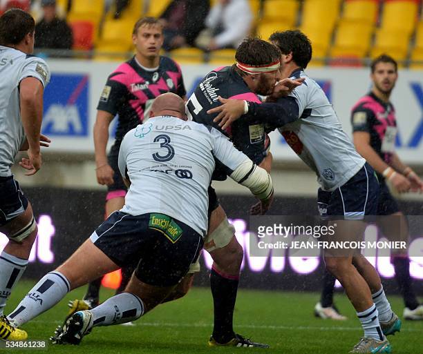 Stade Francais Paris' French lock Paul Gabrillagues is tackled by Agen's French prop Arthur Joly during the French Top 14 rugby union match between...