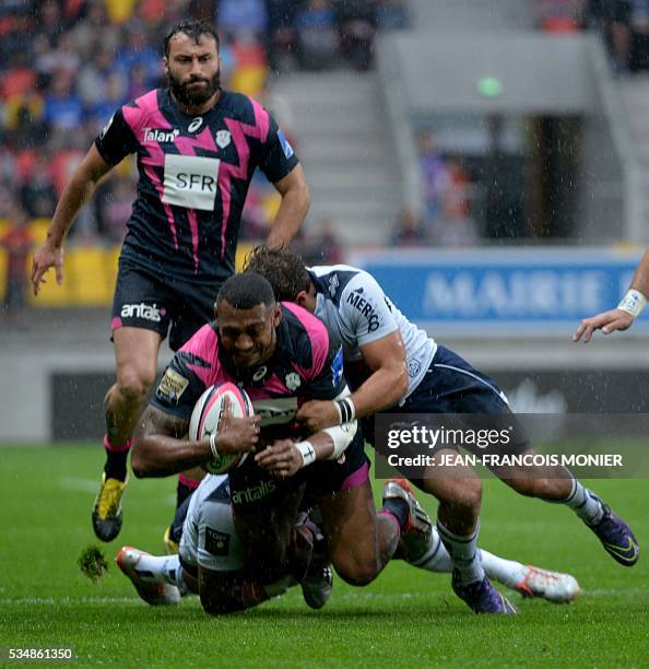 Stade Francais Paris' Fijian wing Waisea is tackled during the French Top 14 rugby union match between Agen and Stade Français on May 28, 2016 at the...