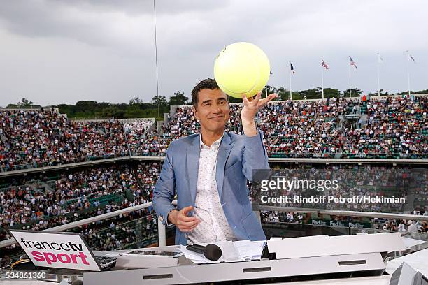 Sports journalist Laurent Luyat plays with a tennis ball at France Television french chanel studio during Day Seven of the 2016 French Tennis Open at...