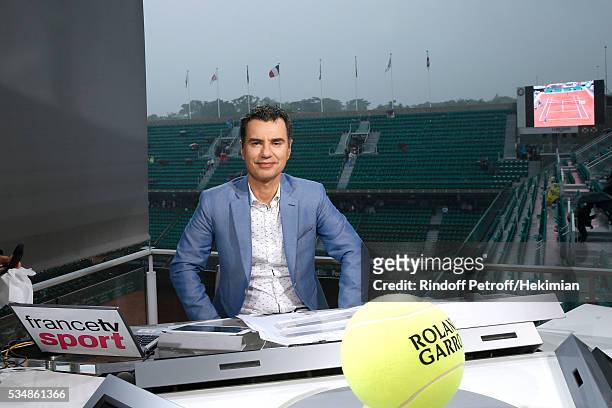 Sports journalist Laurent Luyat poses during a big storm at France Television french chanel studio during Day Seven of the 2016 French Tennis Open at...