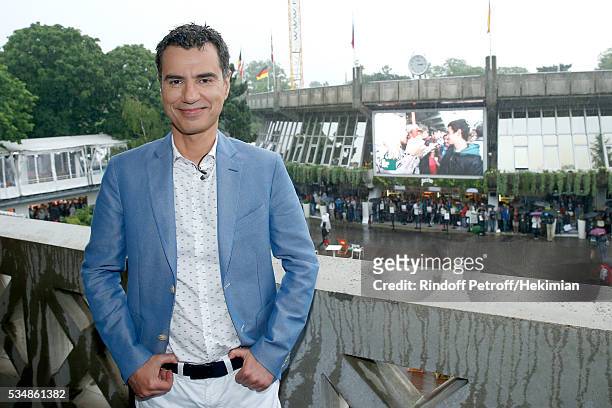 Sports journalist Laurent Luyat poses during a big storm at France Television french chanel studio during Day Seven of the 2016 French Tennis Open at...