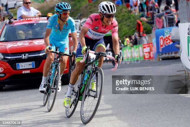 Pink jersey Colombian Esteban Chaves of Orica GreenEDGE and Italian Michele Scarponi of Astana pro team ride during the 20th stage of the 99th Giro...