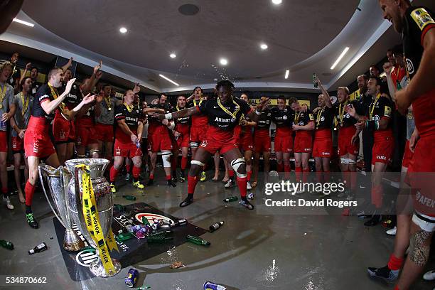 Maro Itoje of Saracens leades the celebratiuons on the dressing room after the Aviva Premiership final match between Saracens and Exeter Chiefs at...