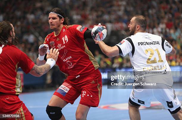 Joan Canellas of Kiel tackles Laszlo Nagy of Veszprem during the second semi-final of the EHF Final4 between THW Kiel and MVM Veszprem on May 28,...