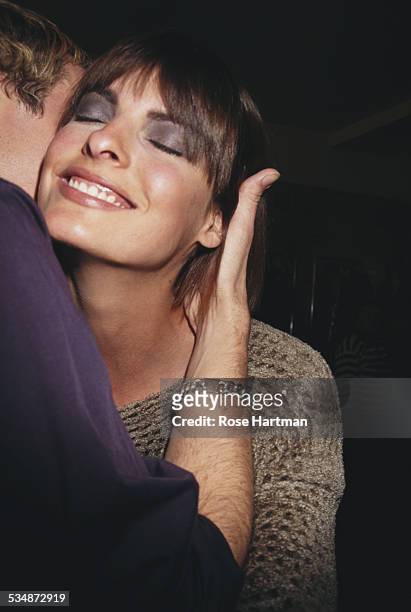 Canadian model Linda Evangelista greeting a friend at the Halston Signature Fall Collection fashion show, 1997.