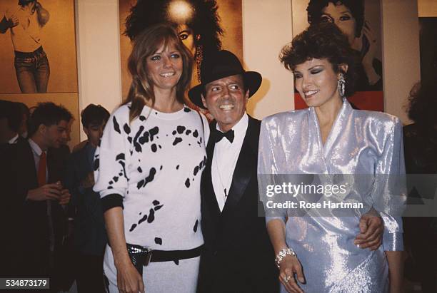 American model and actress Cheryl Tiegs, American fashion photographer Francesco Scavullo and American actresses Raquel Welch at an exhibition...