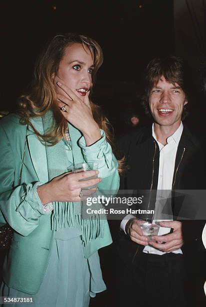 English musician and singer-songwriter Mick Jagger with his girlfriend American model and actress Jerry Hall attend an event being held at...