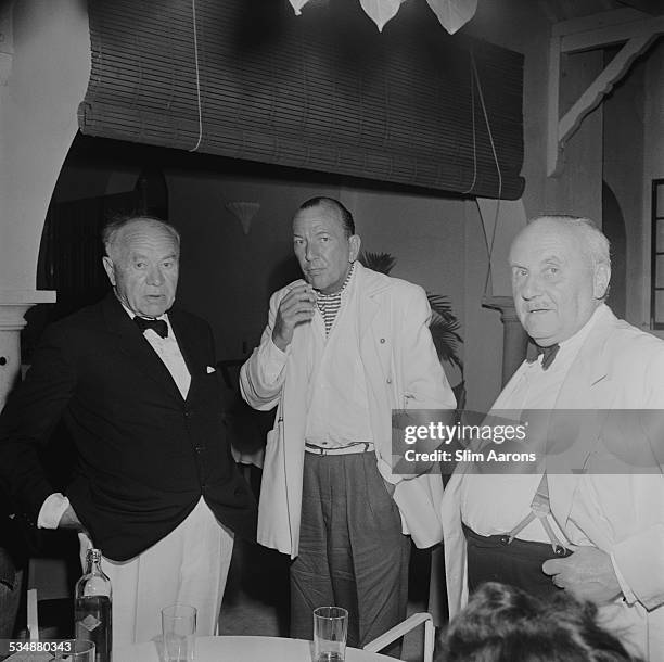 English singer, songwriter, actor and playwright Noel Coward with British intelligence agent and banker Sir William Wiseman and British press magnate...