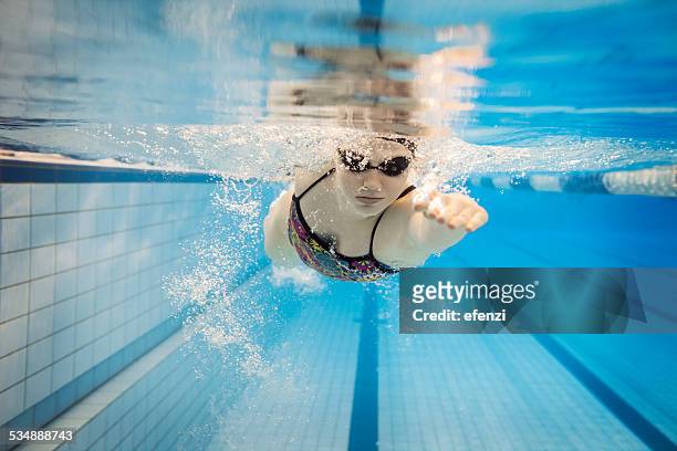 female swimmer underwater - swimming stock pictures, royalty-free photos & images