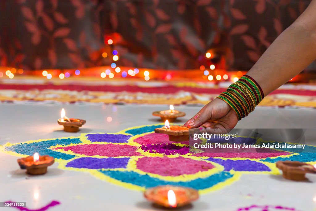Diwali Rangoli decorated with diyas & candle