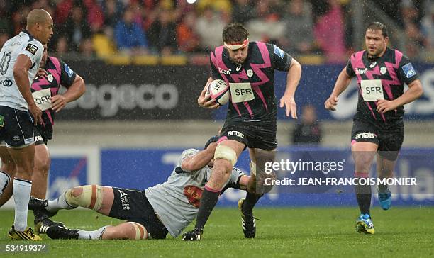 Stade Francais Paris' French lock Paul Gabrillagues is tackled during the French Top 14 rugby union match between Agen and Stade Français on May 28,...