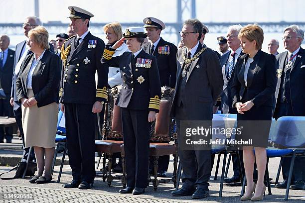 Her Royal Highness Princess Anne, joined by Vice Admiral Sir Tim Laurence and First Minister Nicola Sturgeon listen to The Band of HM Royal Marines...