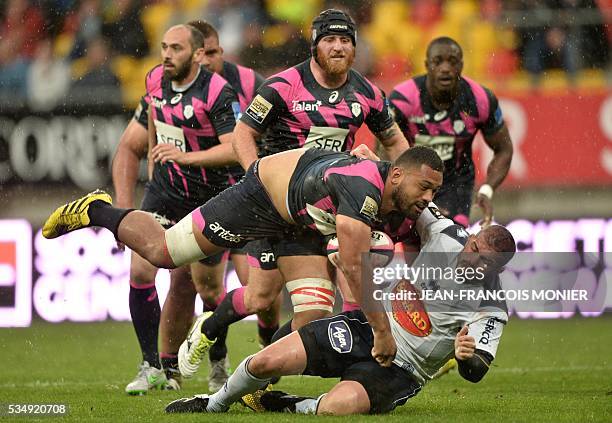 Stade Francais Paris' Australian flanker Patrick Sio is tackled during the French Top 14 rugby union match between Agen and Stade Français on May 28,...