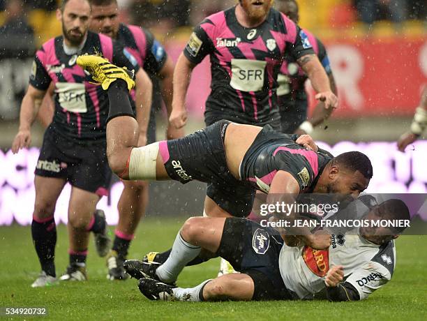 Stade Francais Paris' Australian flanker Patrick Sio is tackled during the French Top 14 rugby union match between Agen and Stade Français on May 28,...